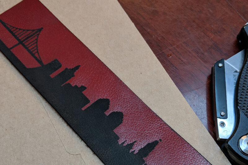 Red leather bracelet with etched Oakland skyline