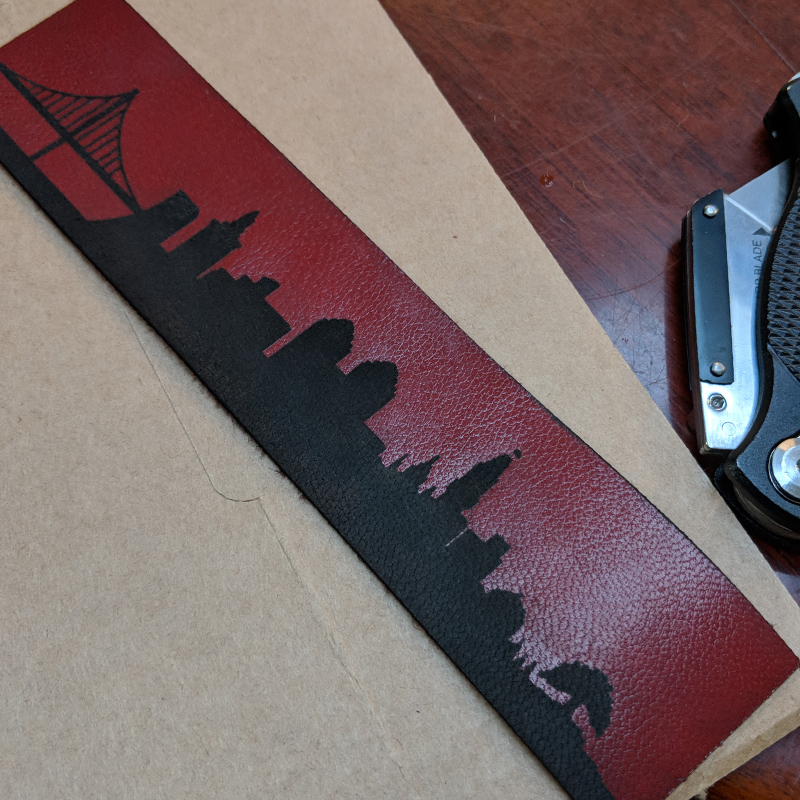 Red leather bracelet with etched Oakland skyline