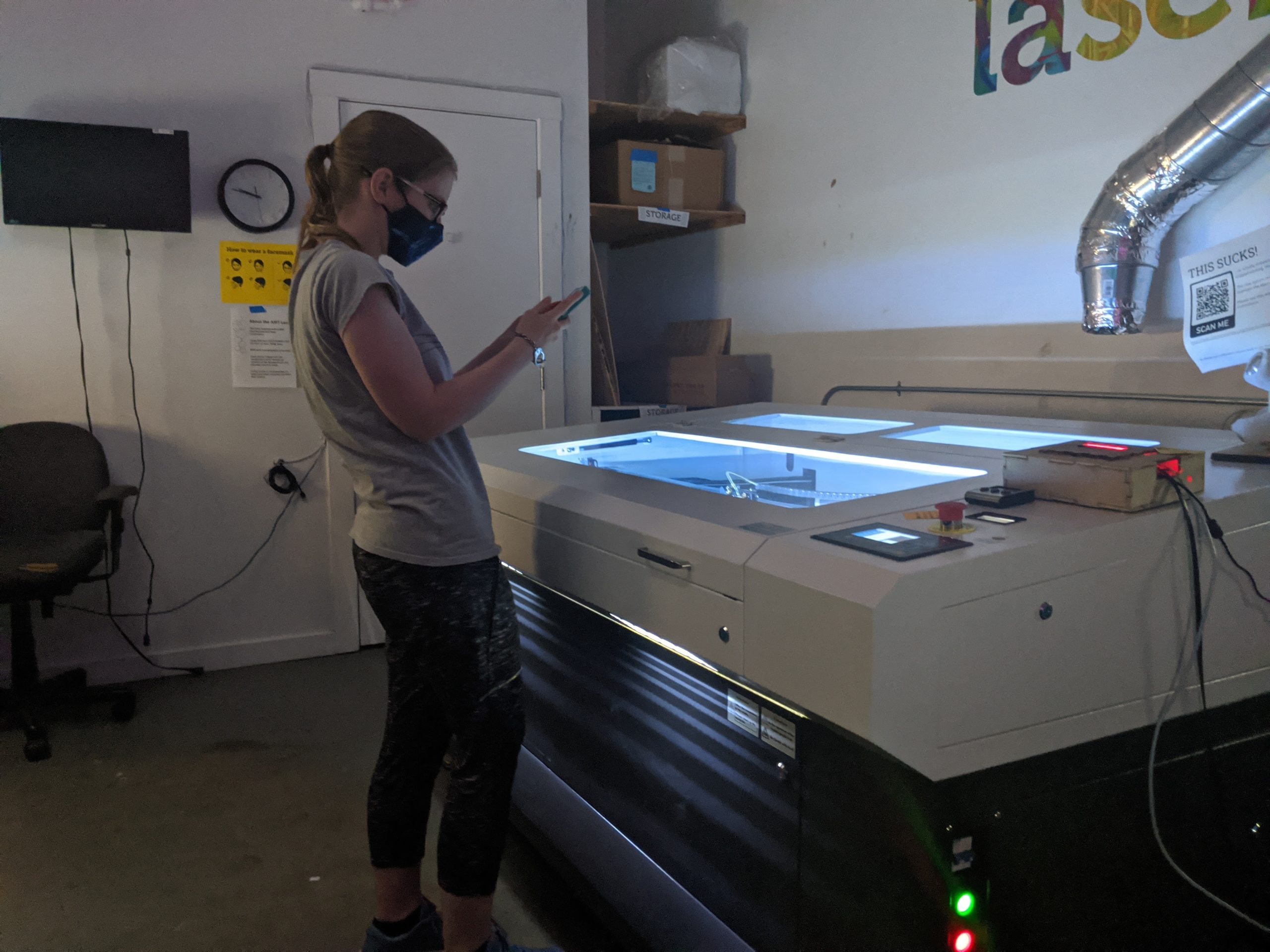 Maker working on a project at the laser cutter