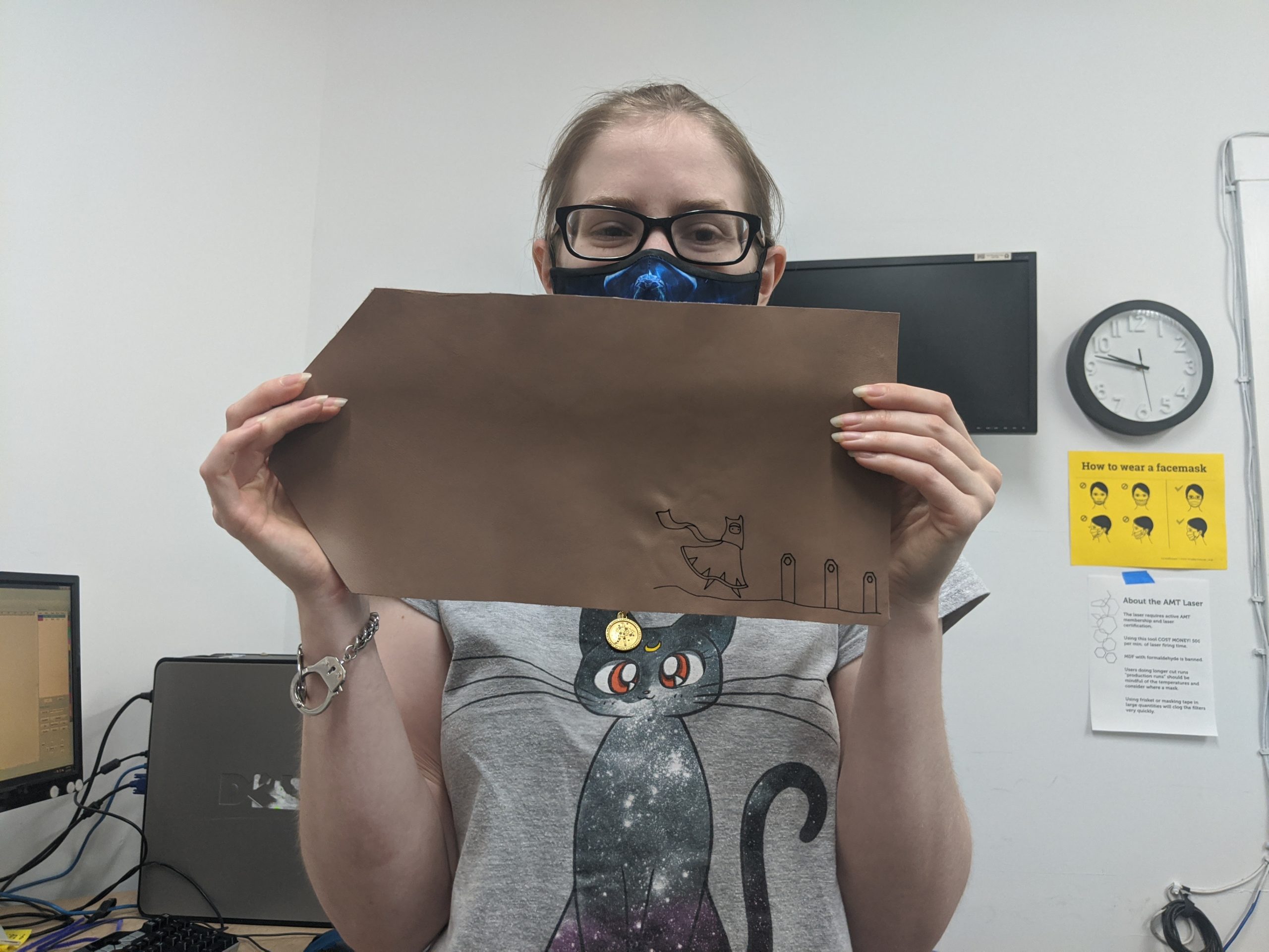 Ace member showing off a finished laser engraved leather project