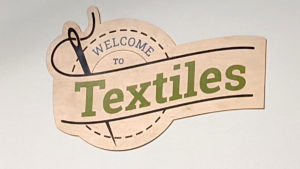 welcome to textiles sign