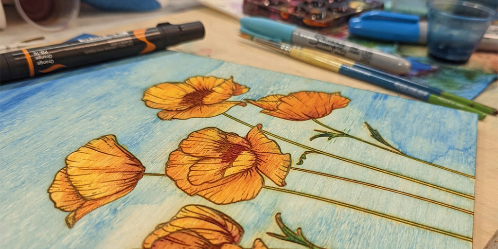 ink on wood orange poppies