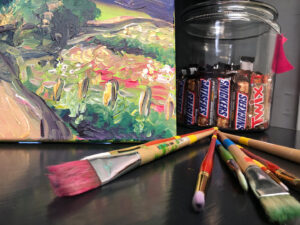 Landscape painting, paintbrushes, snacks. 