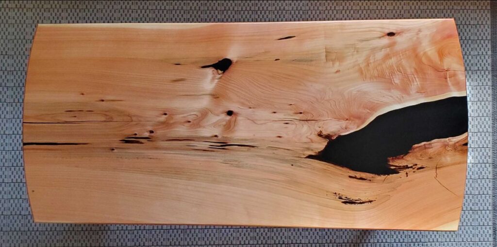 Tabletop made from Monterey Cyprus and black epoxy resin.