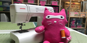 Sewing machine, pink plushy, thread