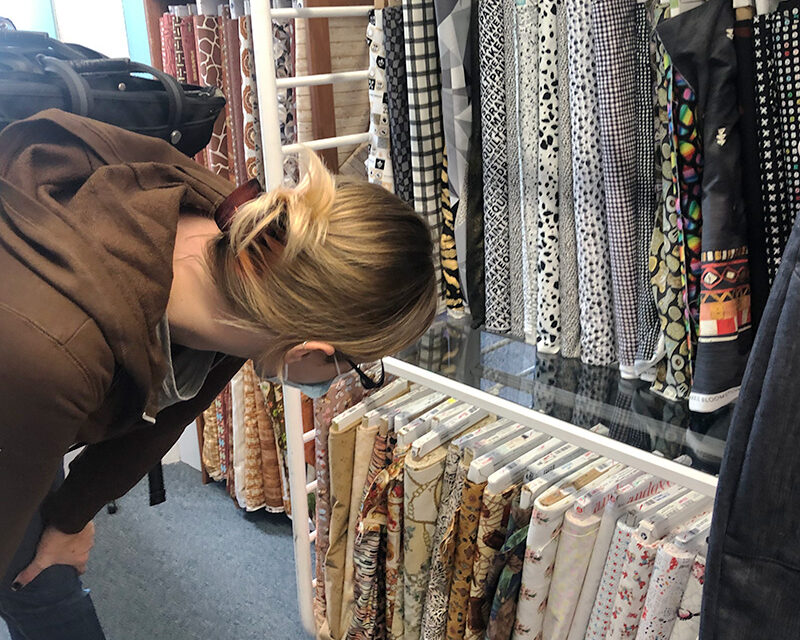 Person looking at fabric in fabric store