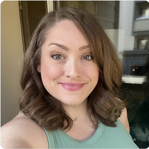 Person in green tank top smiling.