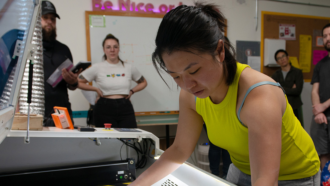 Person in yellow shirt, laser, students