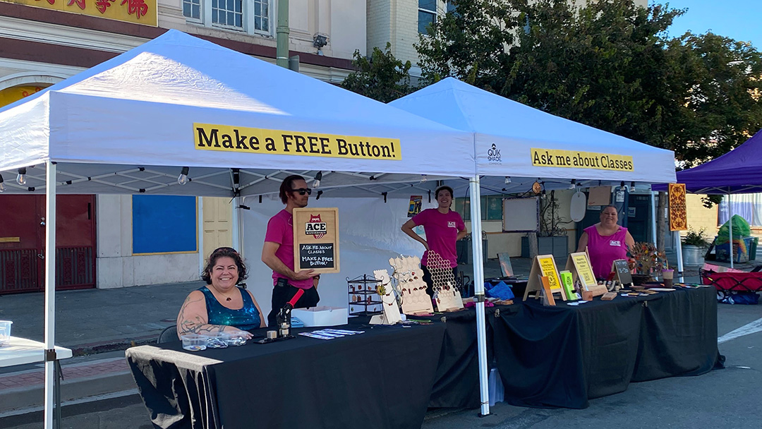 Booth, people, "Make a FREE Button" sign