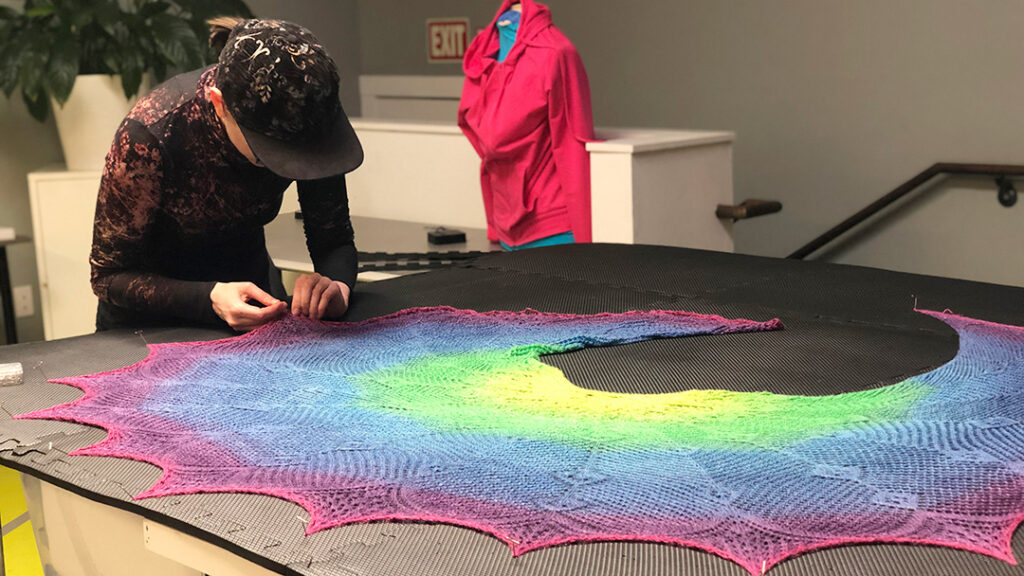 Person blocking rainbow shawl