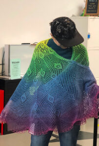 Person in gradient knit shawl