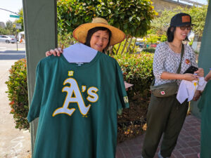 Person holding up a modified "A's" shirt.