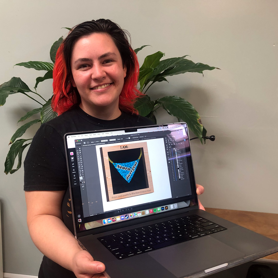 Person holding laptop with jewelry design