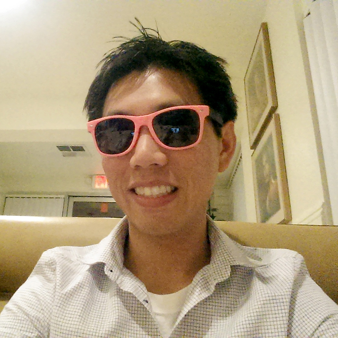 Person smiling in sunglasses.